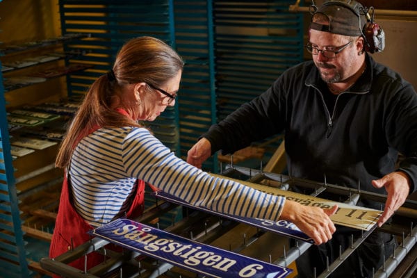 Skillinge Emalj emaljskylt - lägger skyltarna på plats på rastret inför en sista textbränning.