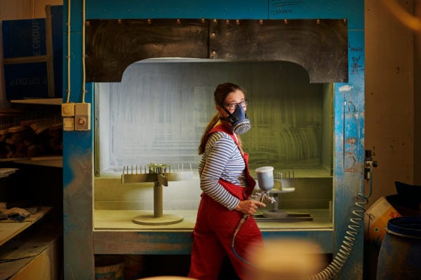 Skillinge Emalj emaljskylt - Helena redo för emaljering framför sprutboxen.